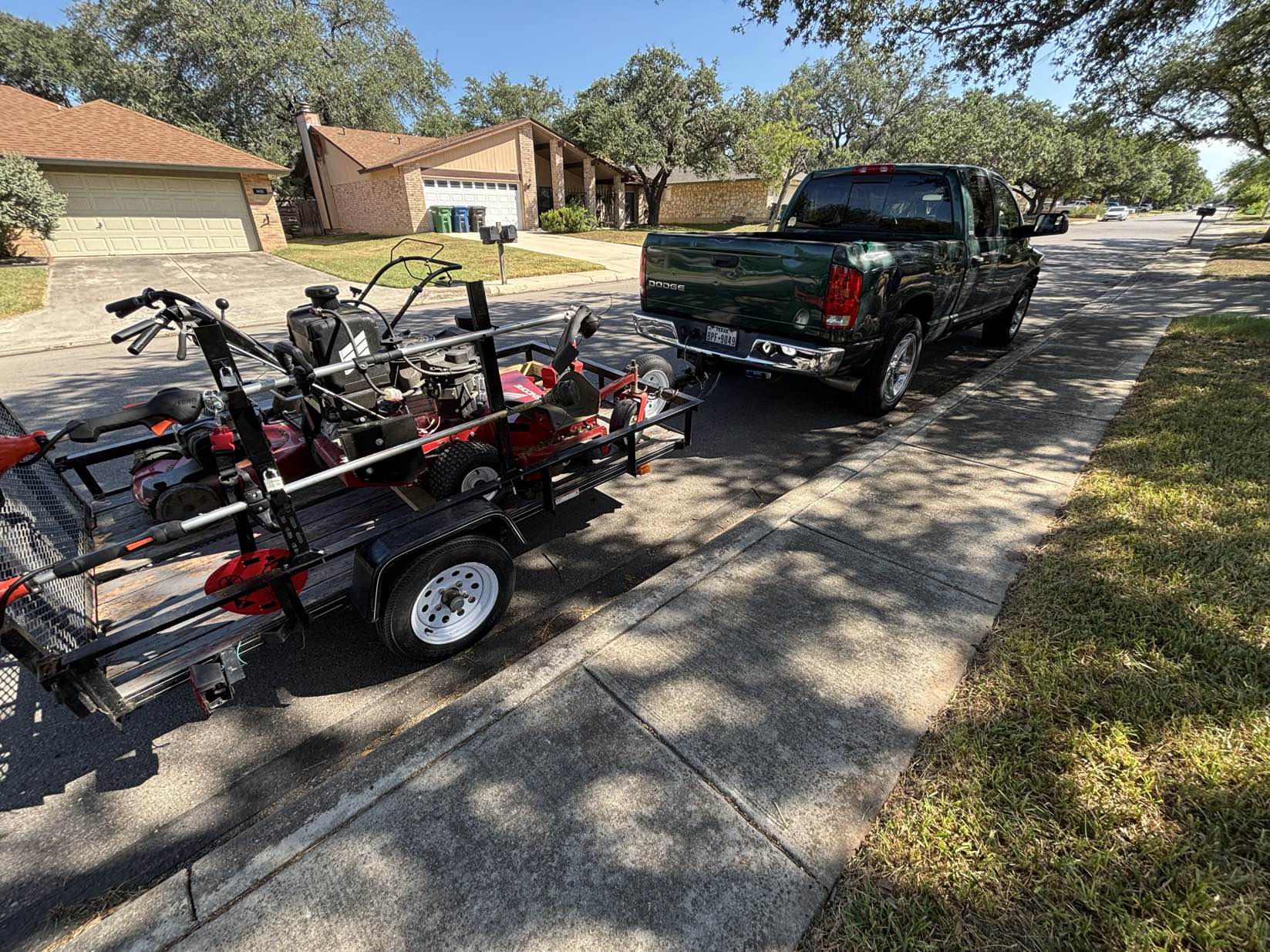 Urban Landscaping work truck and equipment trailer loaded and ready for jobs in San Antonio